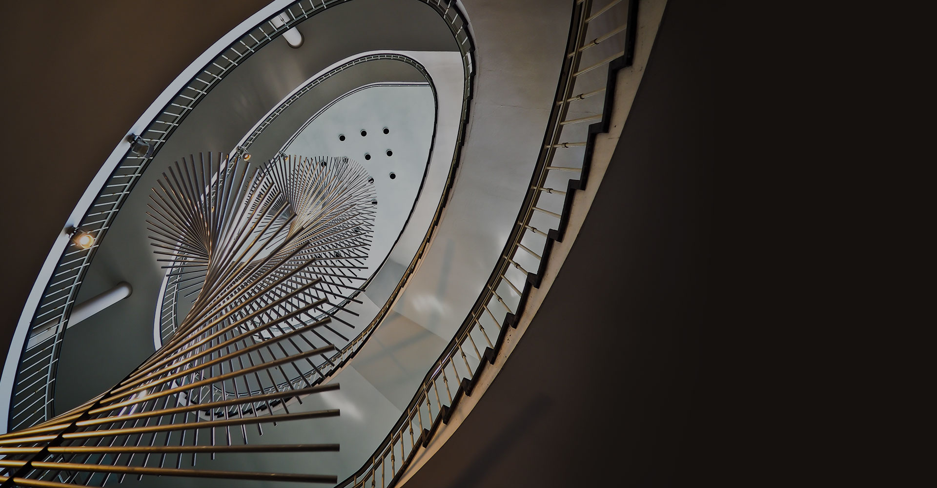 Overhead view of a spiral staircase with a circular skylight