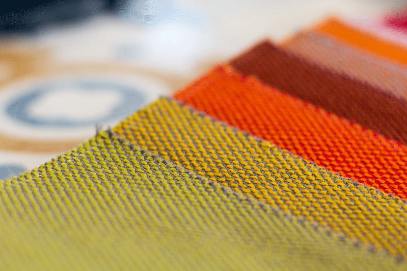 Close-up of layered orange, red and yellow fabric swatches