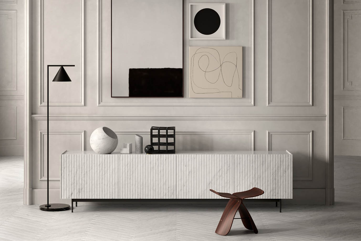 Living room wall with a white sideboard, abstract artworks and a wooden stool