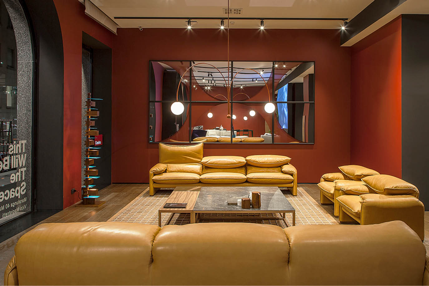 Showroom with yellow leather sofas and a red wall
