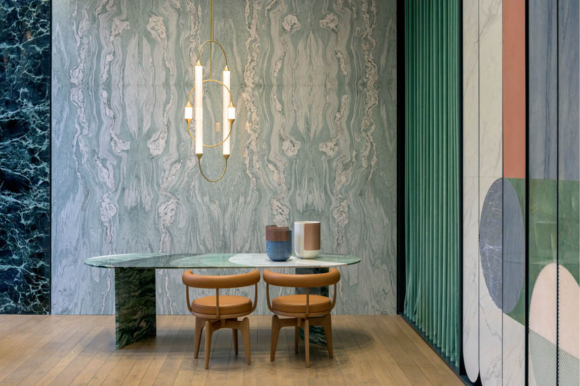 Dining table with leather chairs in front of a marble wall