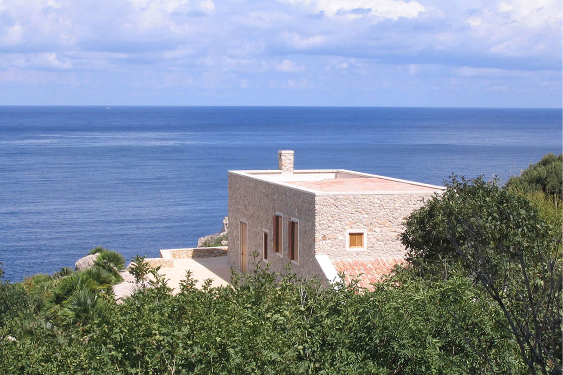 Stone villa on a hillside overlooking the sea