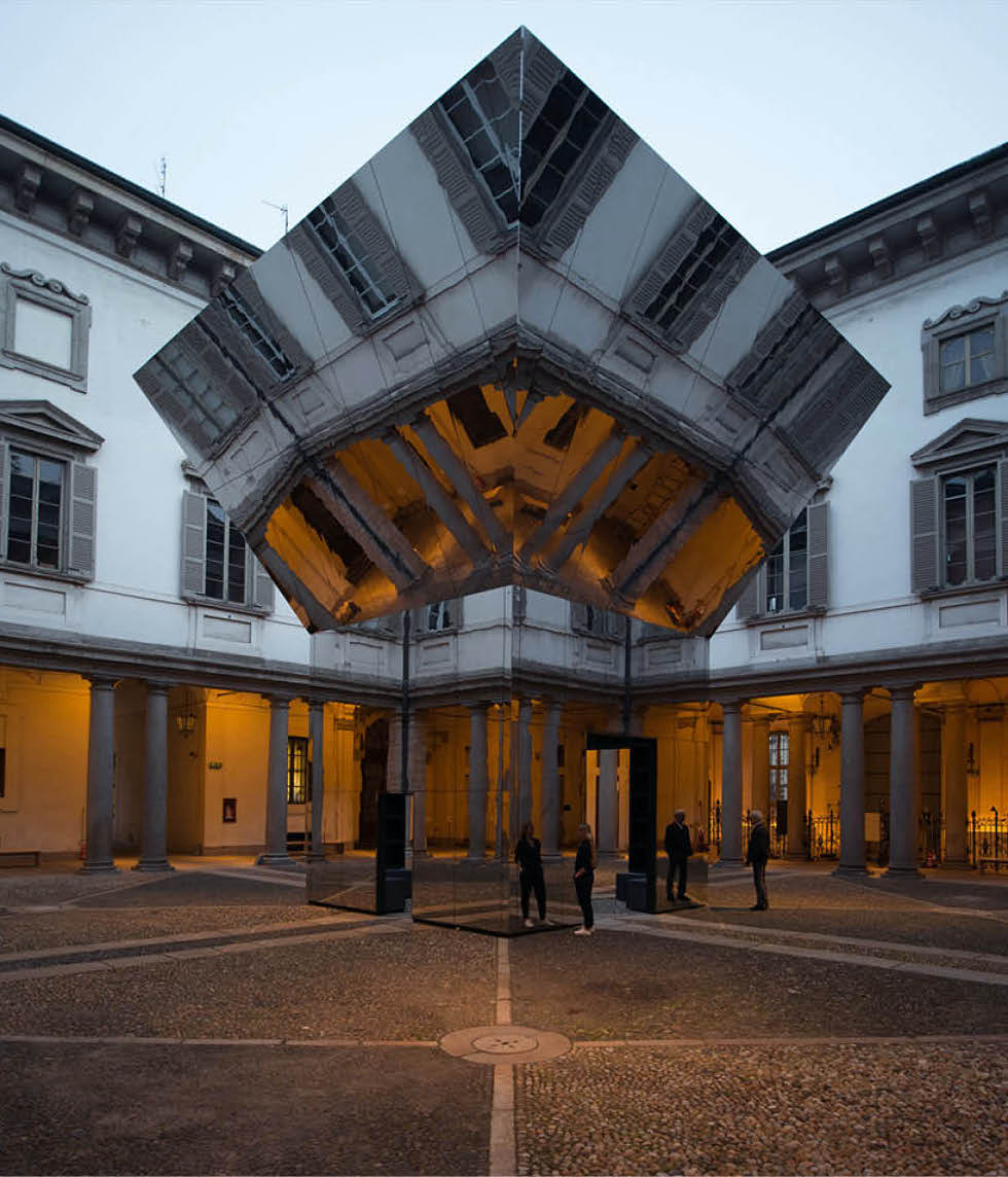 Mirrored angular pavilion installation in a courtyard