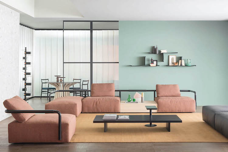 Living room with a pink modular sofa against a mint green wall