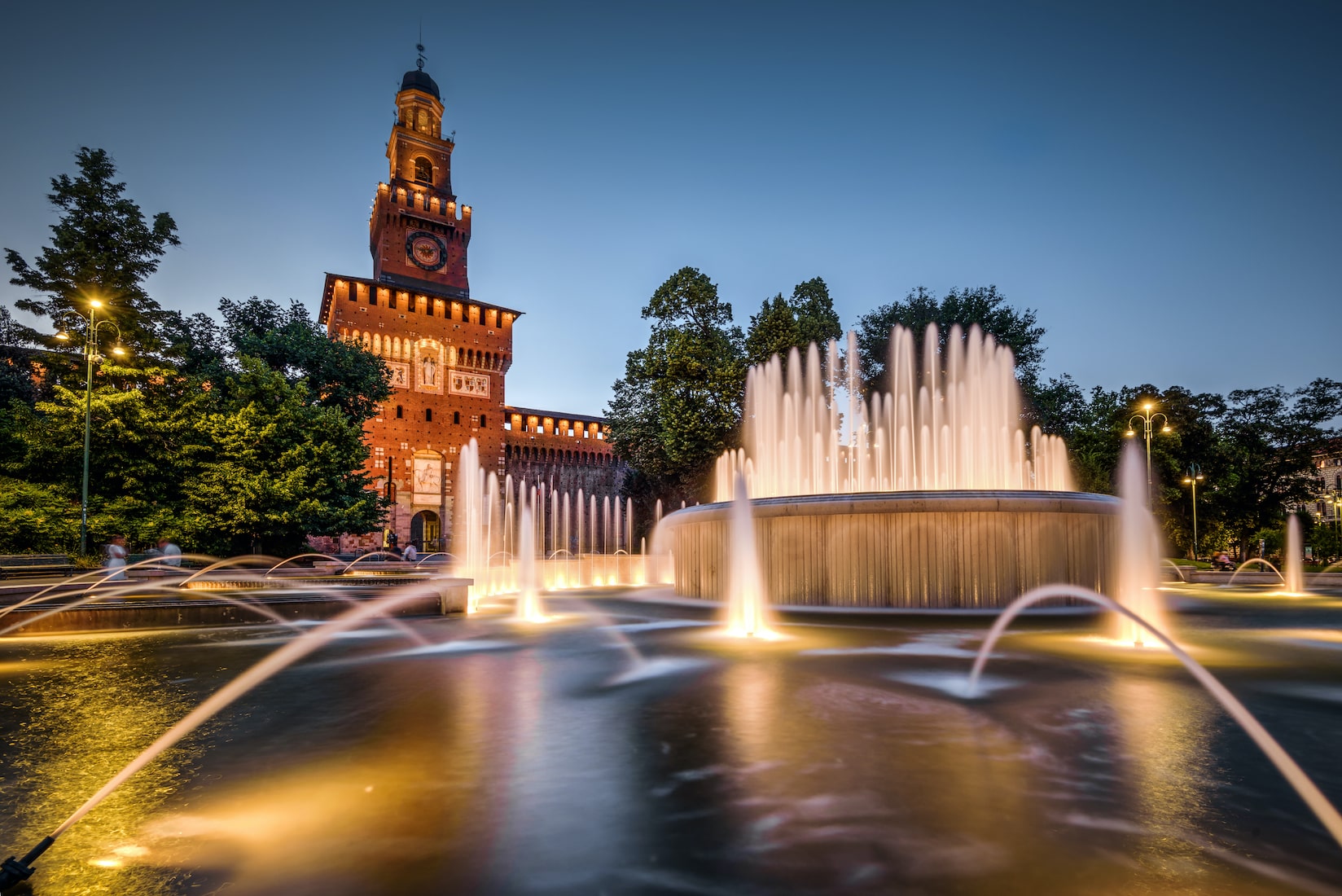 Castello Sforzesco in Milan with its fountain at dusk