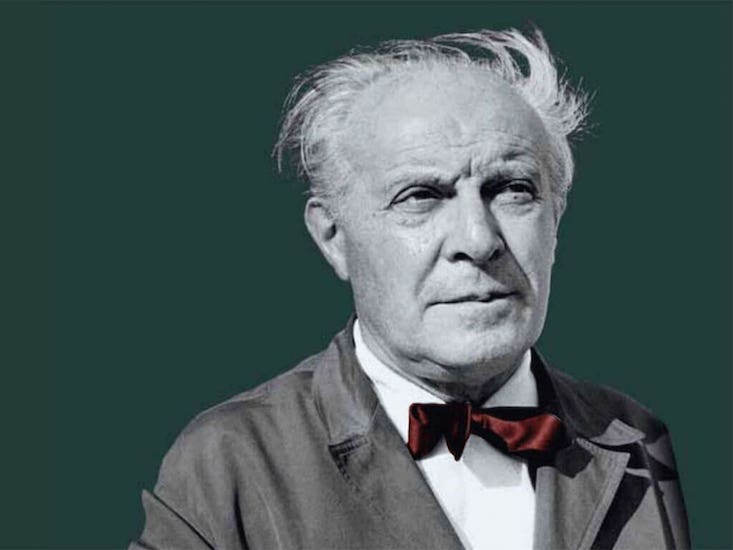 Black-and-white portrait of an elderly man with a red bow tie on a green background