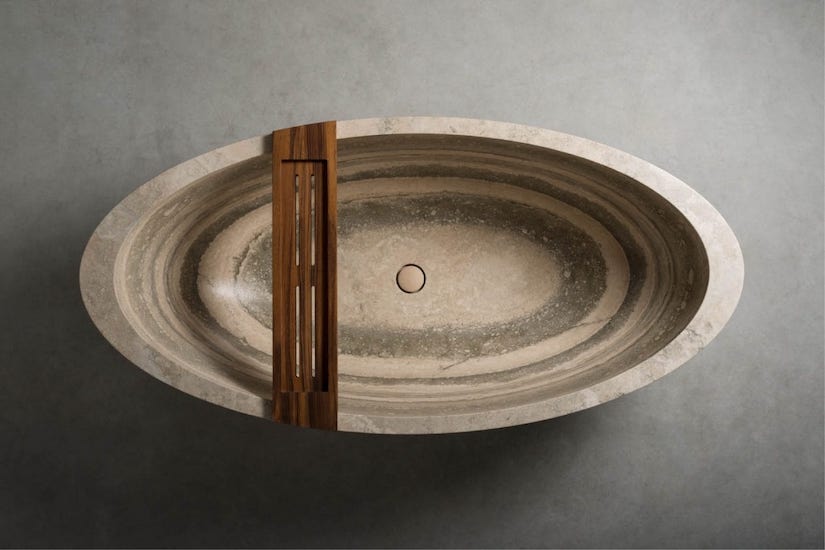 Oval stone bathtub with a wooden insert, seen from above