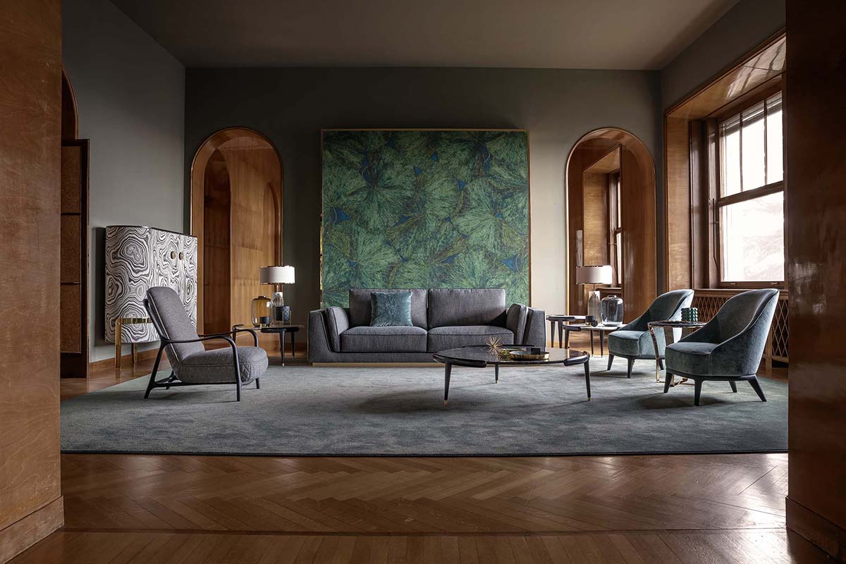 Living room with a grey sofa, arched wood doorways and a malachite-pattern cabinet
