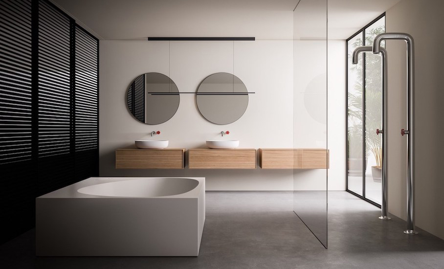 Minimalist bathroom with a freestanding white tub, floating double vanity, round mirrors and a glass shower screen