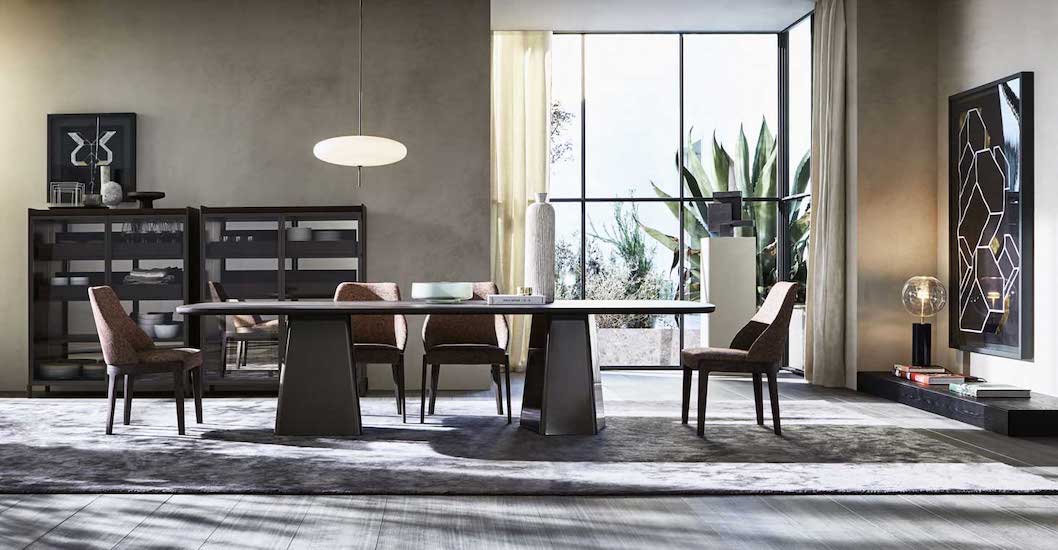 Dining room with a marble table, dark display cabinets and a hexagon-pattern wall panel