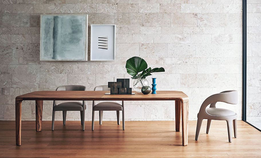 Dining room with a wooden table, curved chairs, an open shelving unit and a wall-mounted pendant lighting arrangement