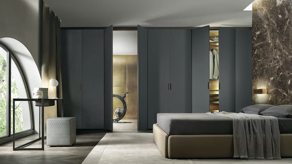 Bedroom with a dark grey wardrobe wall, a brown marble accent wall and low upholstered bed