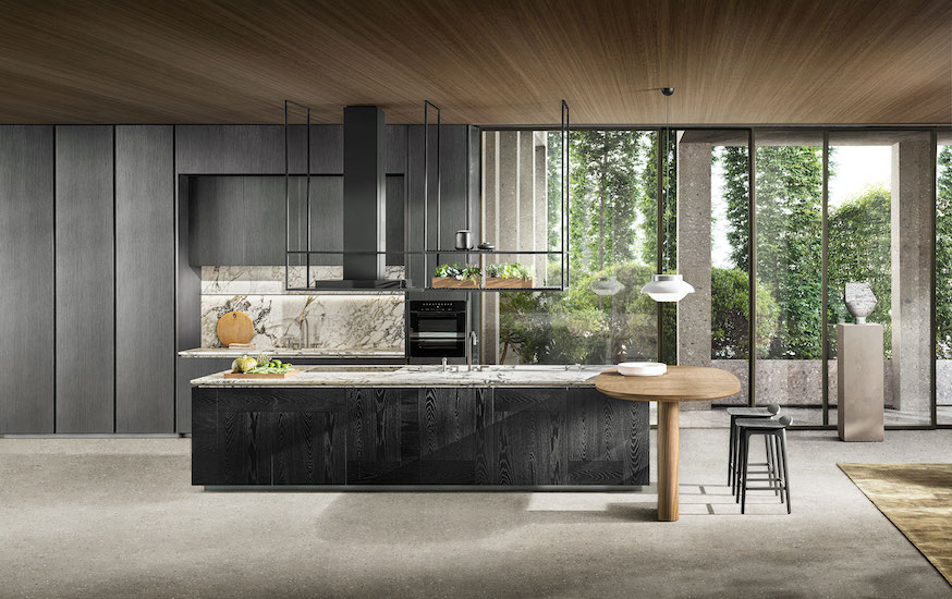 Modern kitchen with grey cabinetry, a marble backsplash, black island and glass doors onto a garden